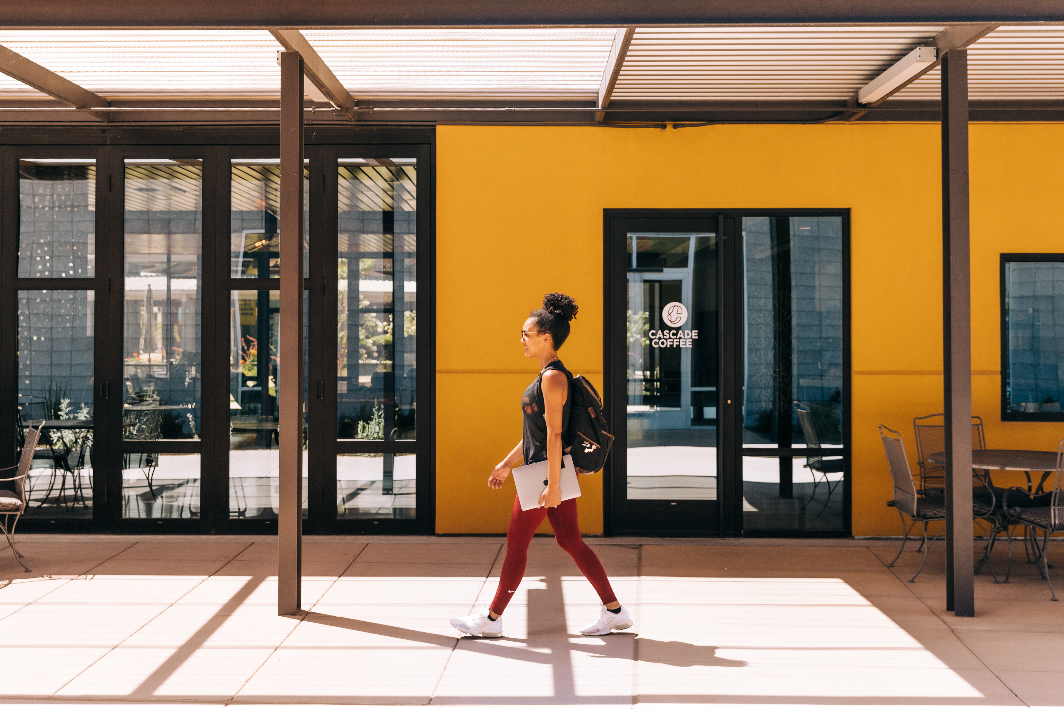 Health and Wellness Guru walking with computer to set up her Showit Website.