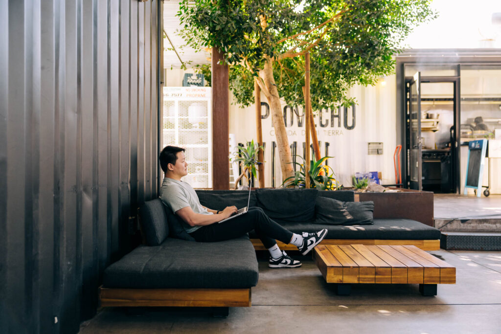 Alt: Photographer pricing page wireframe on laptop and phone highlighting three-tier packages.