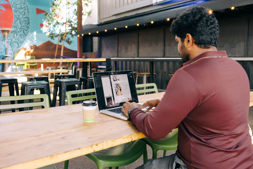 Man building a website on a computer. Do you need a website article.