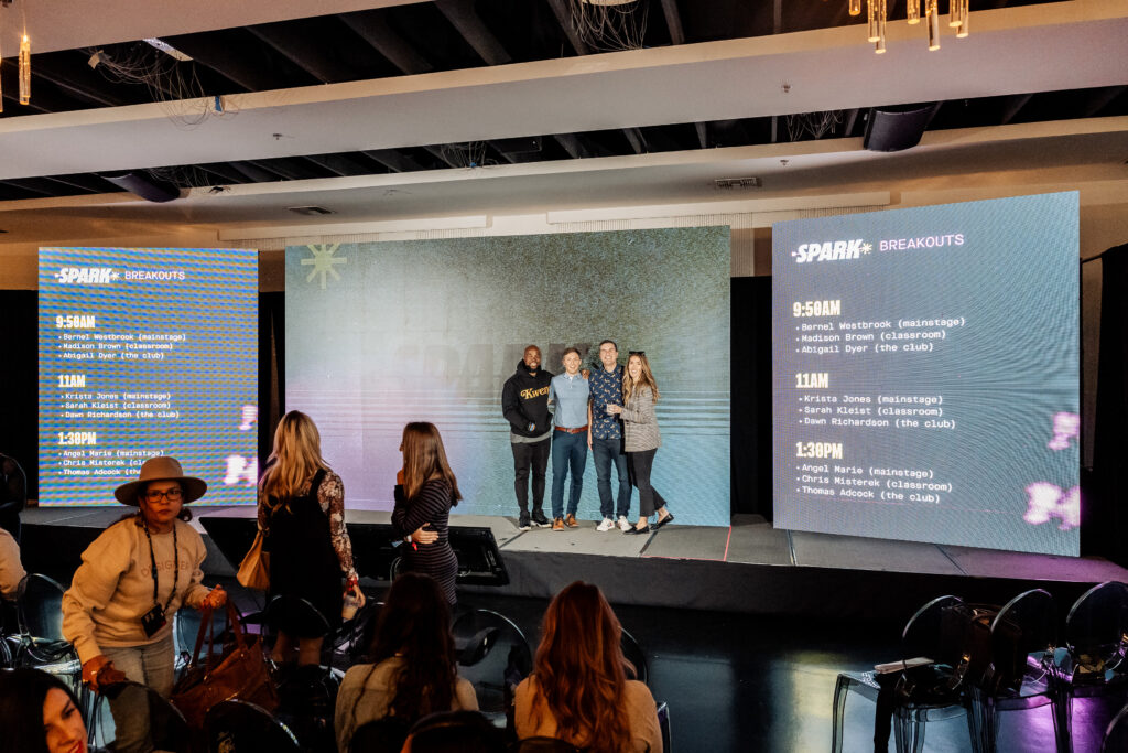 A stage with thought leaders at a creative conference.
