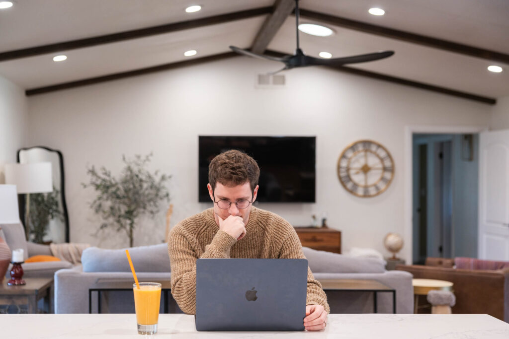 Figma Sites. Vs Showit: man working on a laptop.