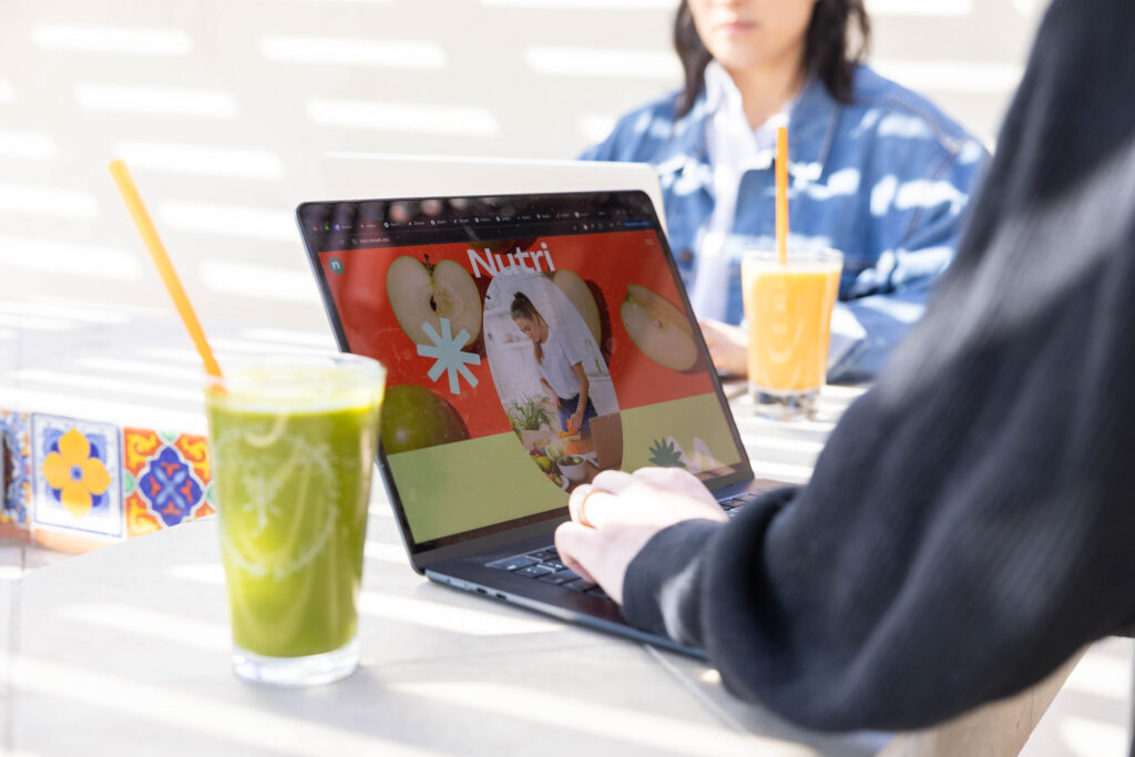 Figma Sites. Vs Showit: woman working on a laptop.