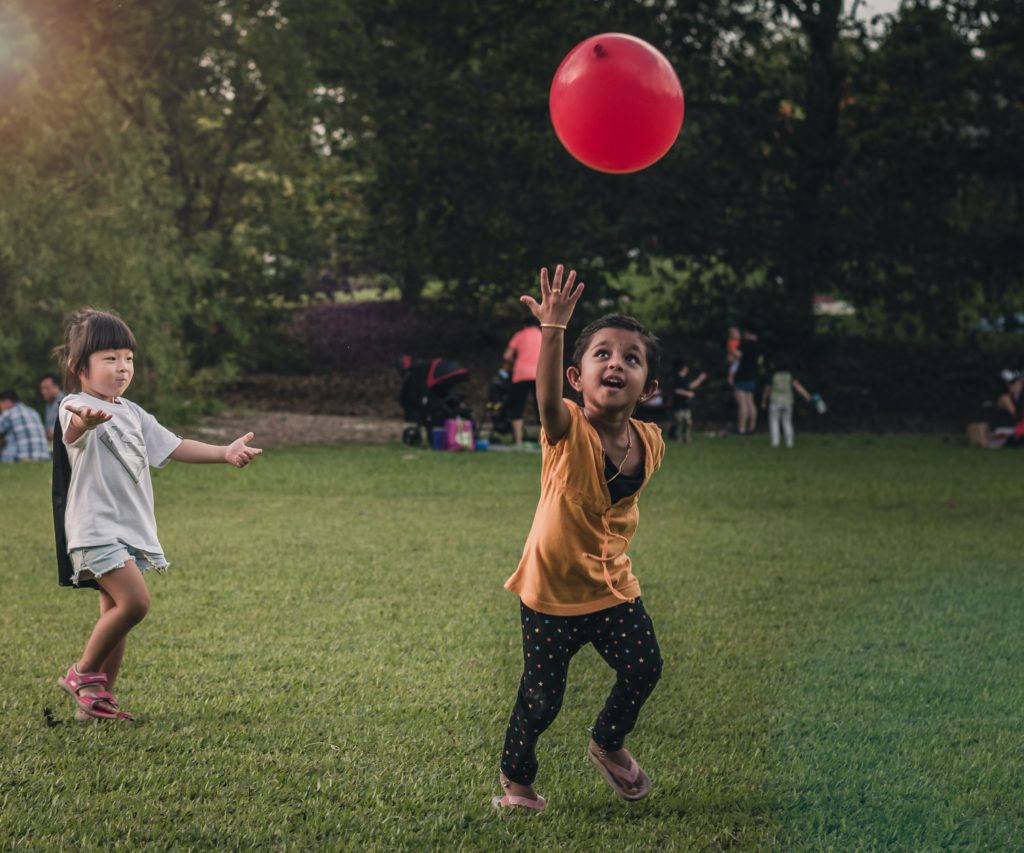 kids playing with balloon in park