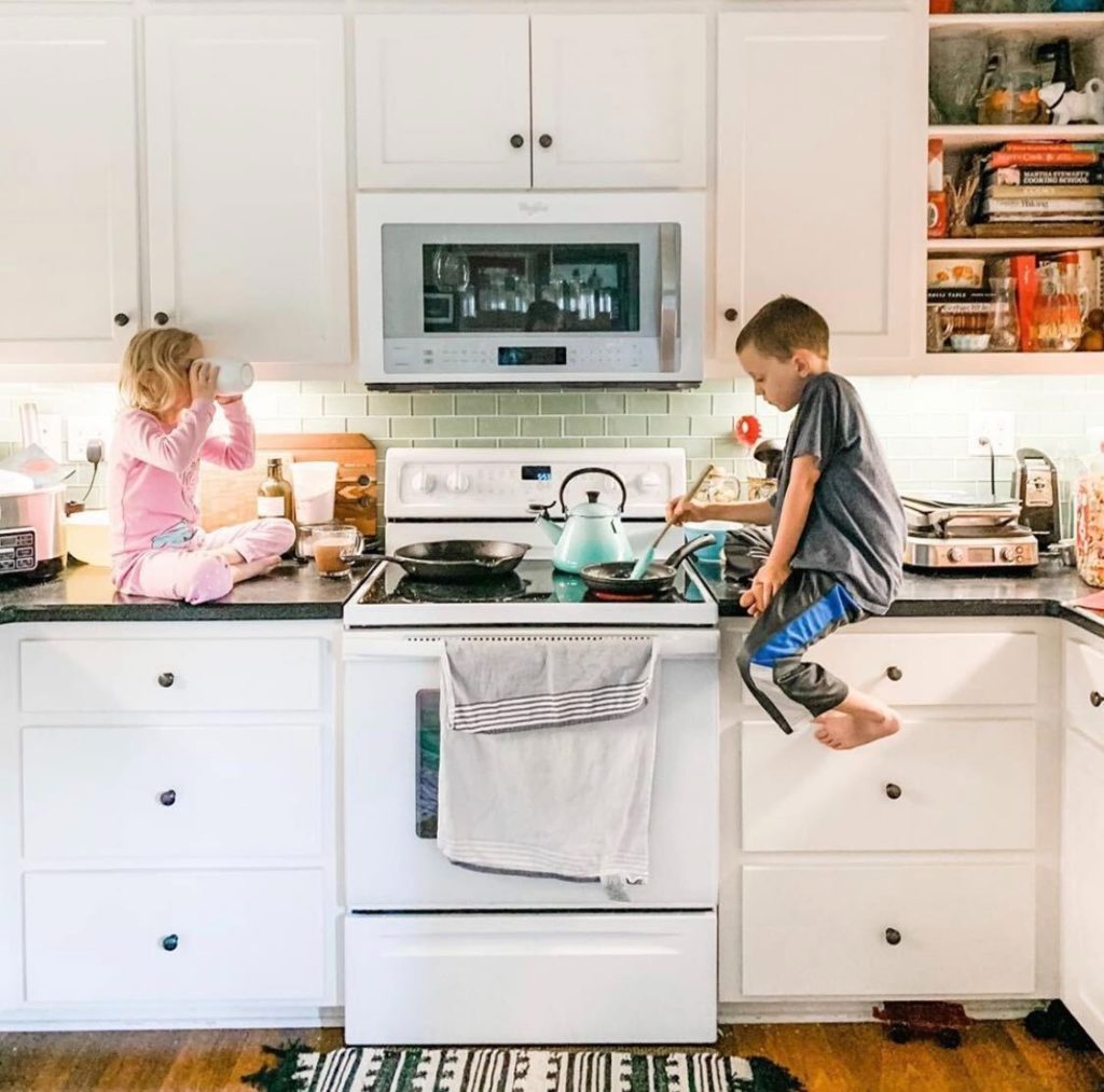kids on counter cooking and eating