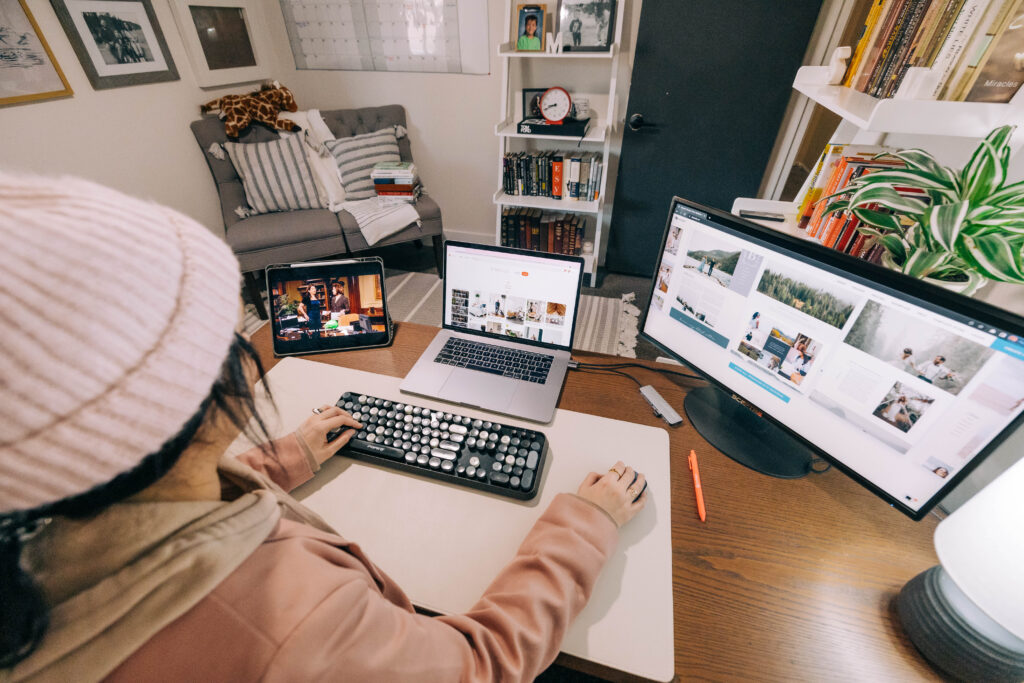 Woman sitting at a desk typing for the How to Update a Website blog.